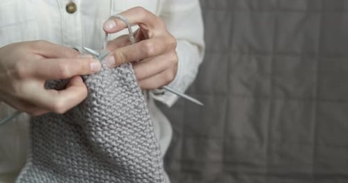 Hands Knit Gray Wool Garment with Needles