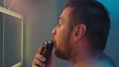 Closeup of a Man Shaving His Beard with a Trimmer