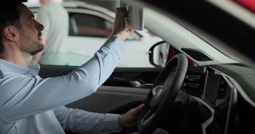Portrait of Handsome Man Touching New Car in Showroom Concept of Car Shopping Buying and Dealership