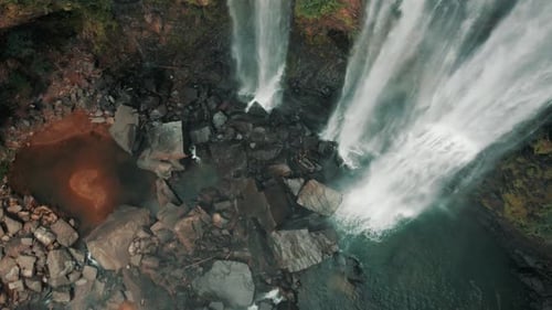Breathtaking Top Down View Of Mist Rising From Rocky Waterfall