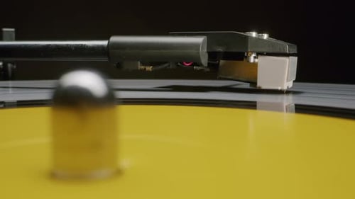 Close Up Record Player Needle on Yellow Vinyl