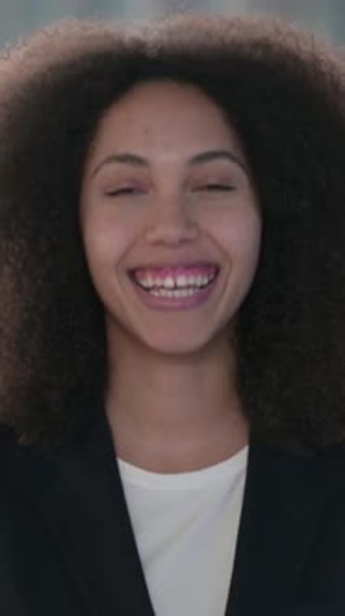 Smiling Young Adult Woman with Afro Hairstyle in Portrait