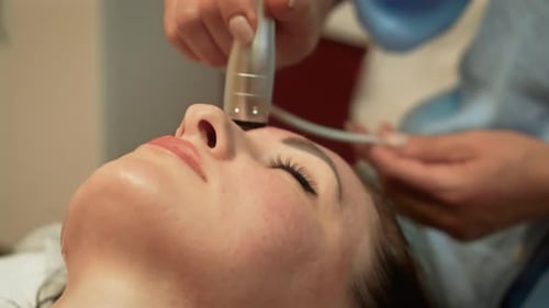Woman Undergoing Relaxing Face Massage From Trained Beautician at Skincare Clinic Ultrasonic Skin