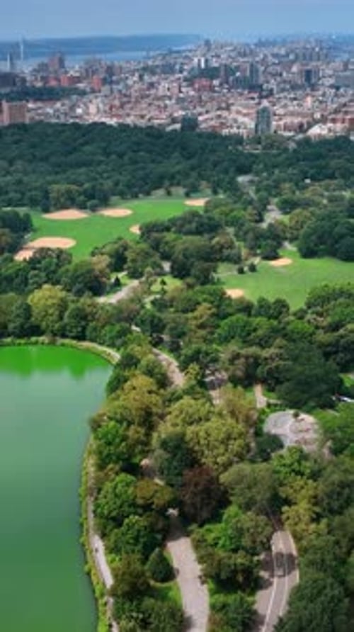 Marvelous scenery of Central Park with lake. Sunny cityscape of New York from aerial perspective
