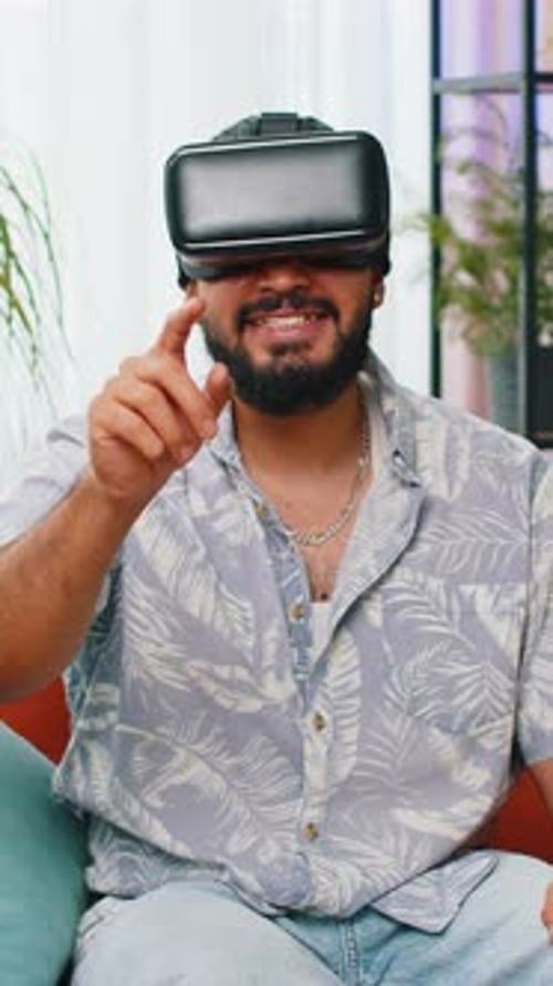 Man Experiencing Virtual Reality with VR Headset Indoors