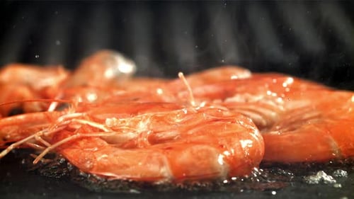 The Shrimp is Fried in a Pan with a Splash Filmed on a Highspeed Camera at 1000 Fps