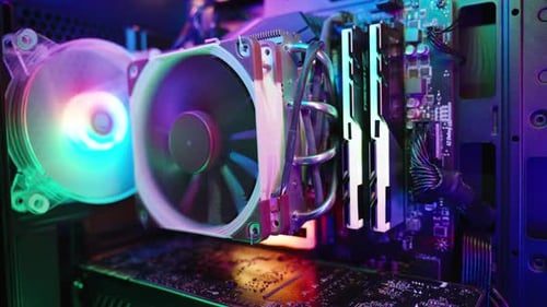 Interior of a gaming desktop PC with rainbow lighting on the RAM heatsink. Close-up.