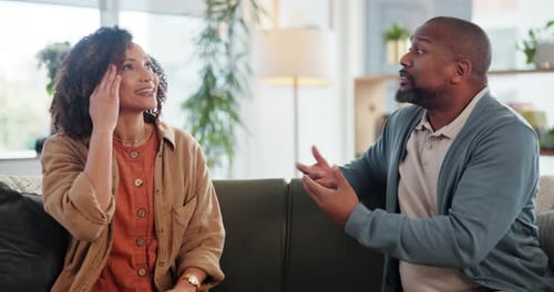 Couple Arguing on Sofa at Home