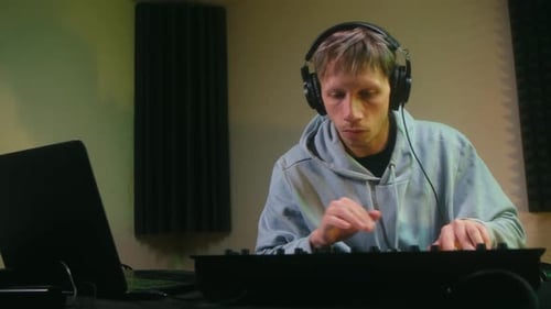 Young Man Plays Keyboard in Recording Studio