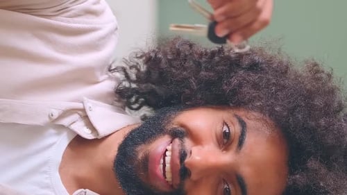 Young Positive Arabian Man Homeowner Shows Keys to New Apartment and Smiles