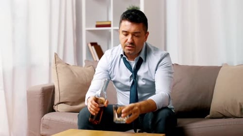 Alcoholism, Alcohol Addiction And People Concept - Male Alcoholic With Bottle Pouring And Drinkin...