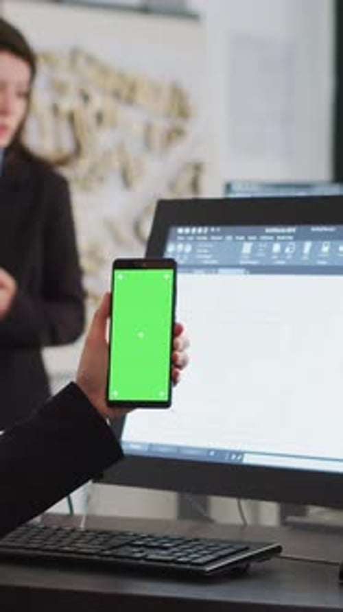 Vertical Video Engineer Showing Phone with Greenscreen Template on Display