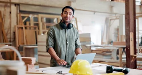 Laptop, carpenter and face of man in workshop for maintenance, remodeling and construction