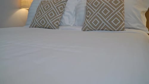 Elegant Hotel Bed with White Sheets and Pillows