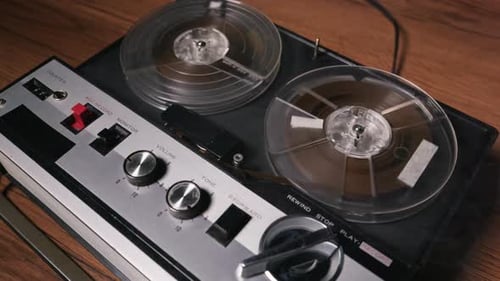Vintage Reel-to-Reel Tape Recorder on a Wooden Table