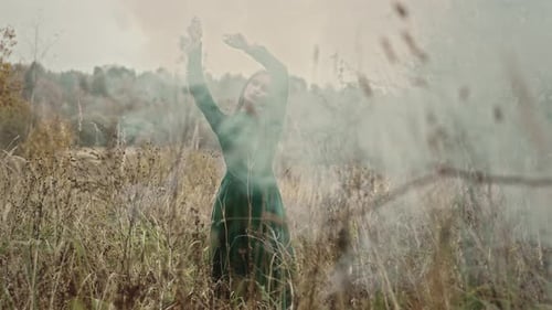 Woman Posing in a Field Wearing Green Dress