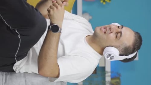 Man Listening to Music with Headphones on Couch