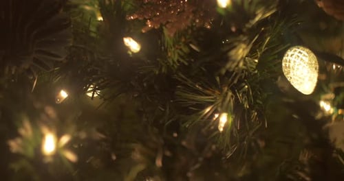 A close up slide on Christmas Tree lights and ornaments, bokeh, selective focus, left to right