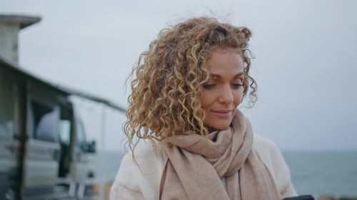Smiling Lady Typing Sms on Cellphone Walking Camper Park on Seashore Close Up