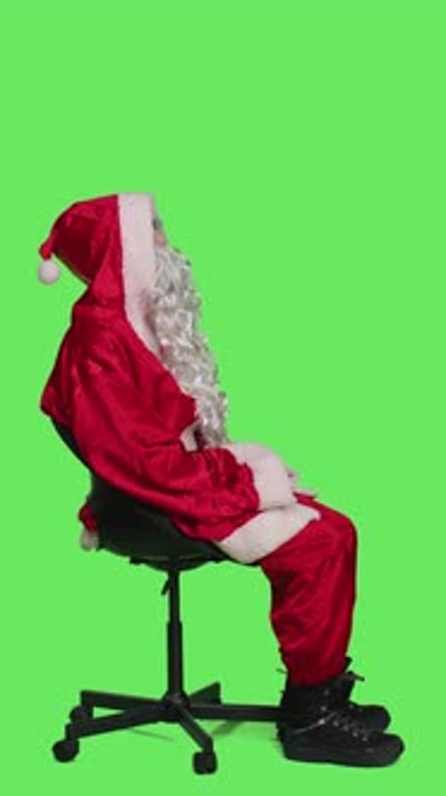 Santa Claus Sits on Office Chair with Green Screen