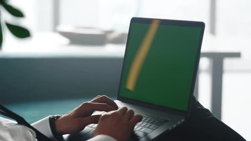 Closeup Unrecognizable Businessman Typing on Laptop with Green Screen. Male Hands Working
