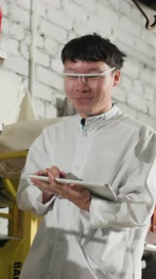 Lab Technician Observing Lifted Car for Technical Analysis in Workshop