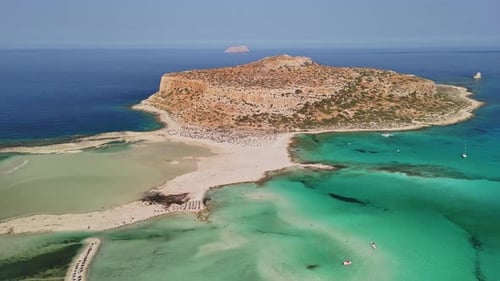 Aerial view of a stunning coastal island in Crete on a clear summer day