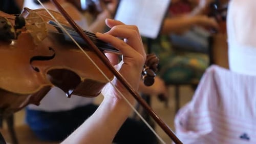 Violin Player Playing Violin in an Orchestra