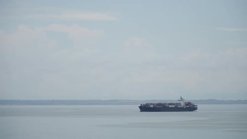 Large Loaded Container Ship is Anchored in Bay at Sea Outdoor on Sunny Wheather