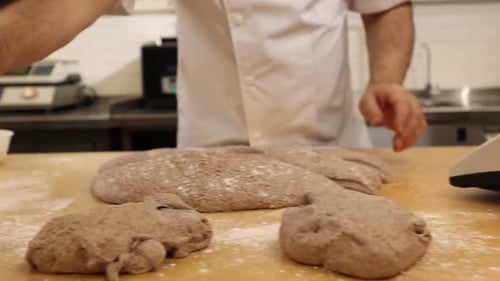 a chef makes bread in a bakery