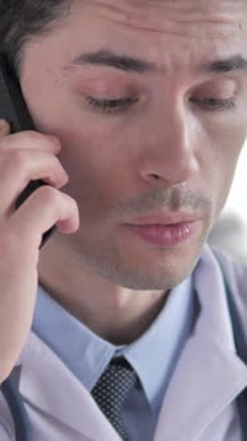 Doctor in White Coat Talking on Phone Close-Up