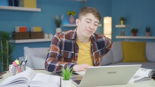 Young Adult Studying then Stretching Back