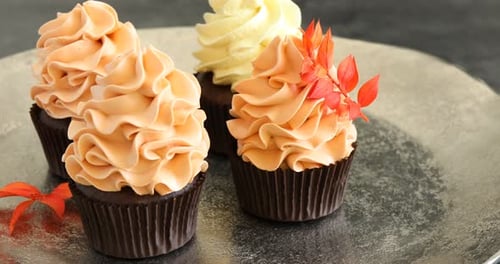 Delicious Cupcakes with Swirled Frosting and Leaf Decoration