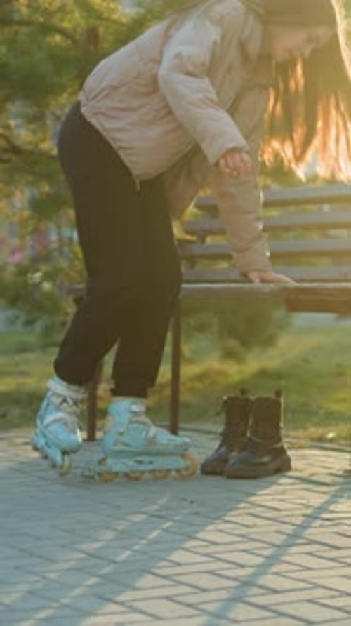 Girl Rollerblading in Park During Sunset Near a Bench