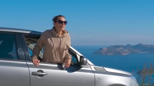 Woman Leans Out of Car Window, Ocean View