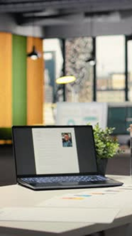 Vertical Video Empty Company Space with a Laptop Showing CV Applicant Before Job Interview