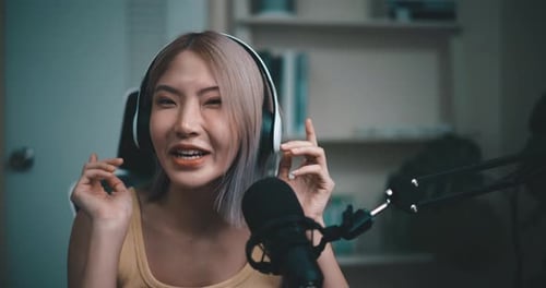 Woman Recording Podcast Wearing Headphones at Home