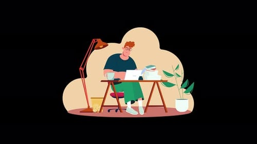 A young man working at a desk with a laptop in a cozy setting.