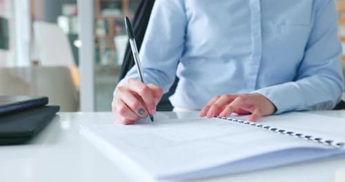 Close Up of Person Writing at Desk