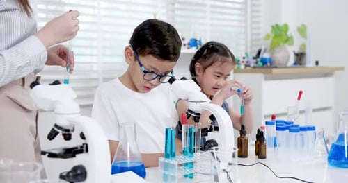 Children Doing Science Experiment in Bright Laboratory
