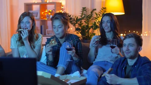 Friendship, Food and Leisure Concept - Happy Friends Eating Pizza and Drinking