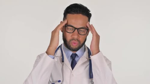 Doctor in white coat holding sides of head