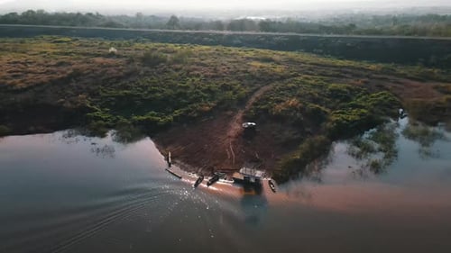 Low tide in the blue artificial lake Mae Ngat Somboon among the green trees in Thailand on a sunny d
