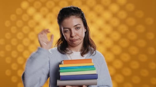 Sulky Lady with Stack of Novels Doing Thumbs Down Hand Gesturing