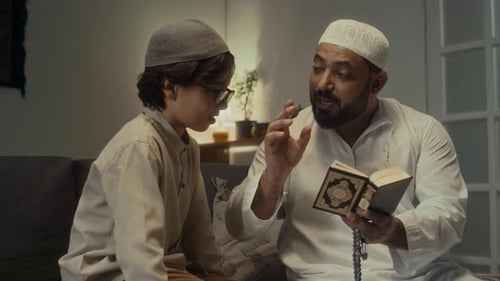 Father Learning Phrases for Praying Namaz with His Little Son