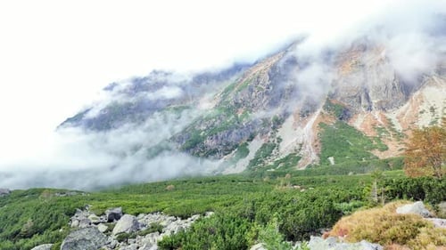Valley in the high Tatra Mountains, clouds are rising up