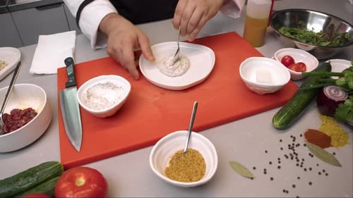 Chef Plates Sauce with Artful Precision in Kitchen