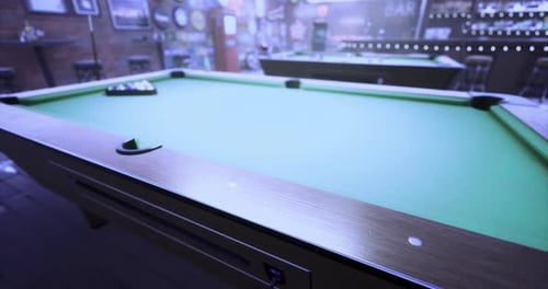 Pool Table Ready for a Game in a Dimly Lit Bar During Evening Hours