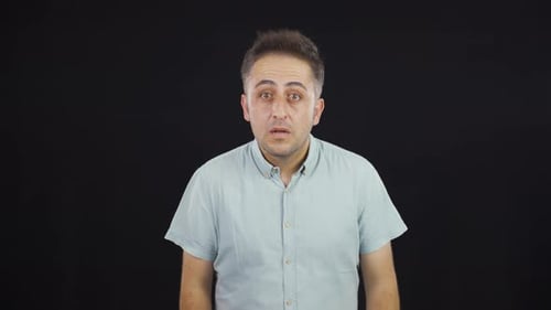 Man Thinking and Gesturing on Black Background