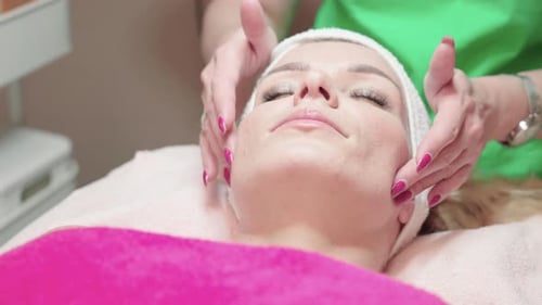 Facial Massage Before Peeling Treatment, Female Patient on Table in Wellness Spa Center, Close Up Sl